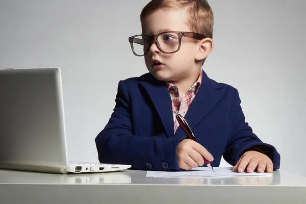 Young businessman using a laptop. Education child in glasses. little handsome boy — Stock Photo, Image