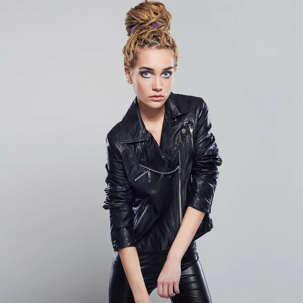 Beautiful girl with dreadlocks hairstyle. punk rock young woman in leather — Stock Photo, Image