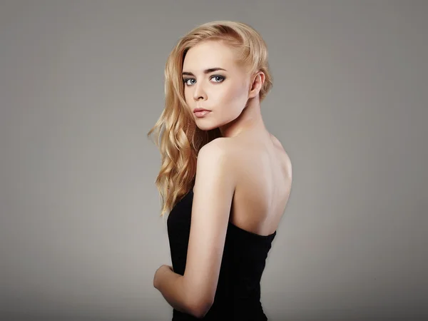 Young beautiful woman in black dress.Sexy Blond girl. Curl Hairstyle — Stock Photo, Image