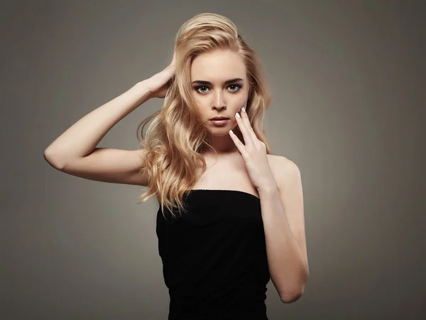 Retrato de moda de bela jovem com cabelo loiro. Menina em vestido preto — Fotografia de Stock