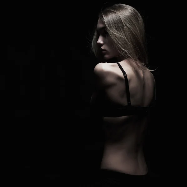 Sadness young woman with naked back over black background. dark monochrome portrait of sexy body girl — Stock Photo, Image