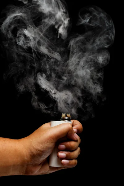 Hand using e-cigarette releasing a smoke — Stock Photo, Image