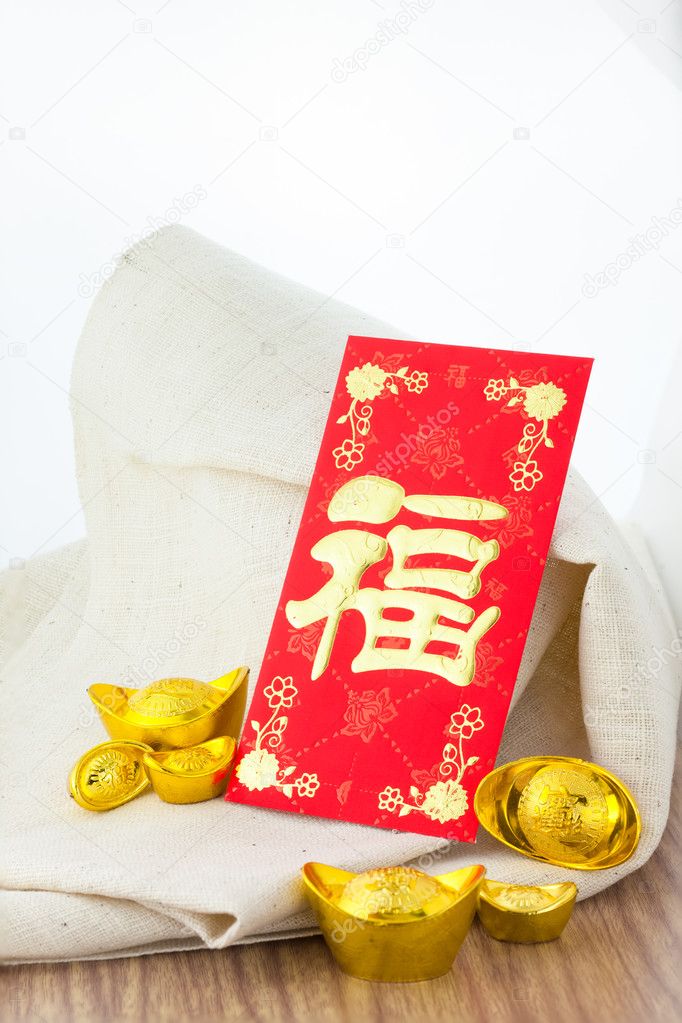 Chinese new year festival decorations on wooden table with gold and red packet Chinese letter 