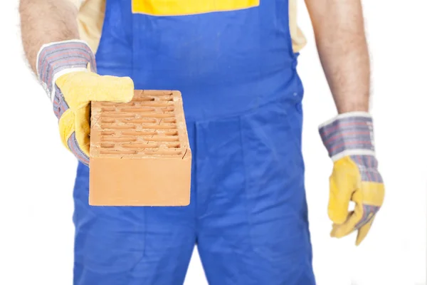 Trabajador con un ladrillo en la mano —  Fotos de Stock