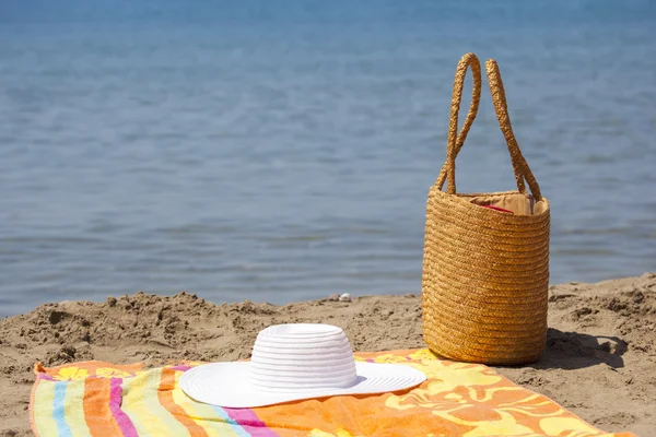 Chapeau sac et serviette sur la plage — Photo