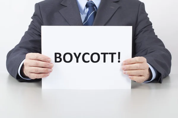 Man Holds a Sheet with a Text Boycott — Stock Photo, Image