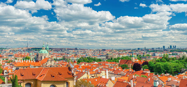Panorama of Prague historical city centre with dome of Saint Nicholas catholic Church, red tiled roof buildings in Mala Strana Lesser Town and Old Town, aerial panoramic view, Bohemia, Czech Republic