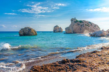 Aphrodite Beach with Stone Rocks in Aphrodite bay of Mediterranean sea water, blue sky in sunny day background, Petra tu Romiou, Cyprus clipart