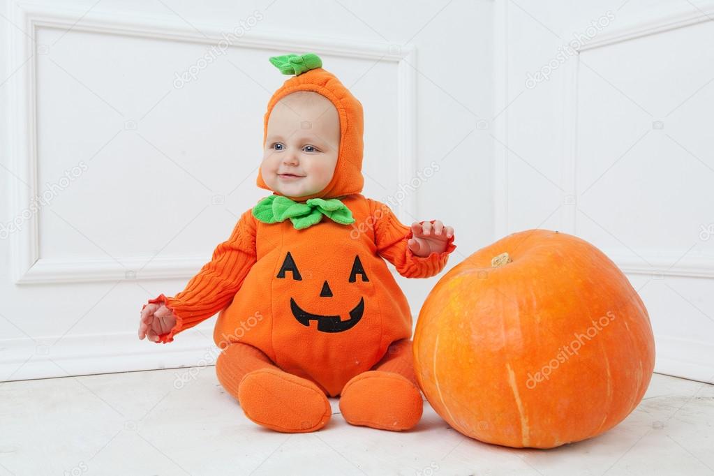 Child in pumpkin suit on white background