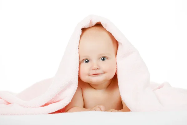 Caucasian baby boy covered with pink towel joyfully smiles at ca — Stock Photo, Image