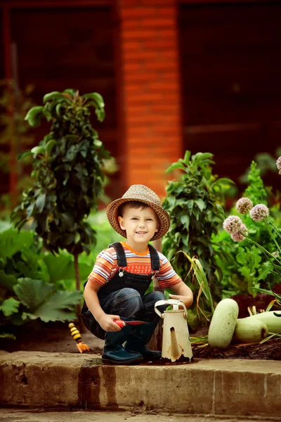 Retrato de um menino trabalhando no jardim de férias — Fotografia de Stock