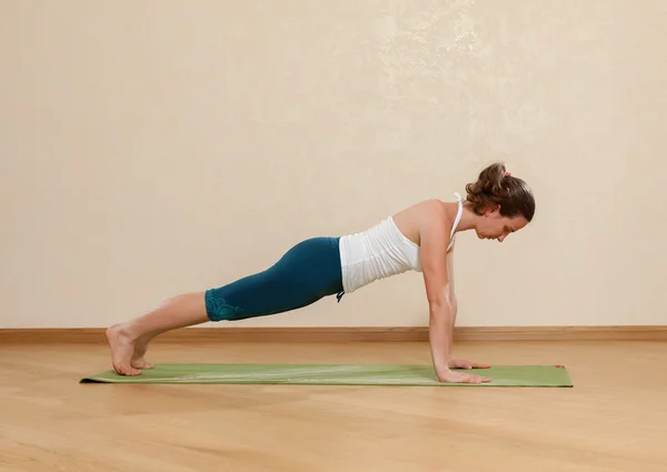 Caucasian woman is practicing yoga at studio (chaturanga dandasa — Stock Photo, Image