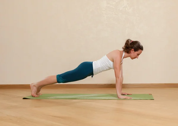 Caucasian woman is practicing yoga at studio (chaturanga dandasa — Stock Photo, Image