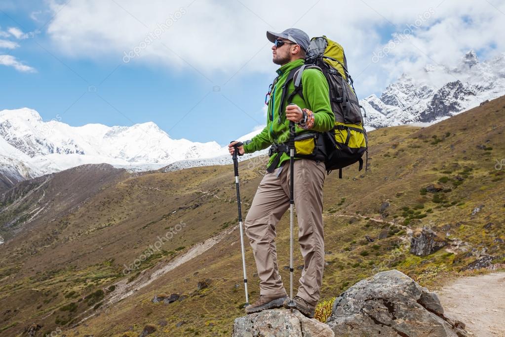 Hiker posing in Himalayas in front of big mountains