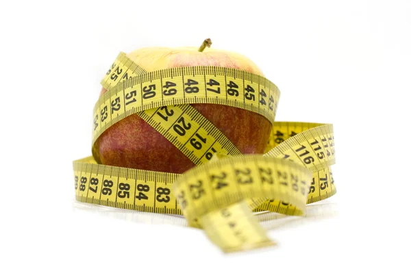 Red apple and tape measure — Stock Photo, Image