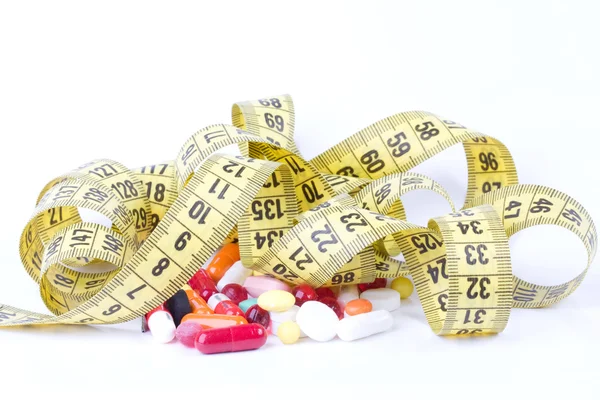 Measure tape with diet pills — Stock Photo, Image