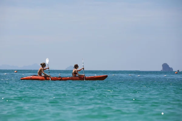 Caucasian woman is kayaking in sea at Thailand