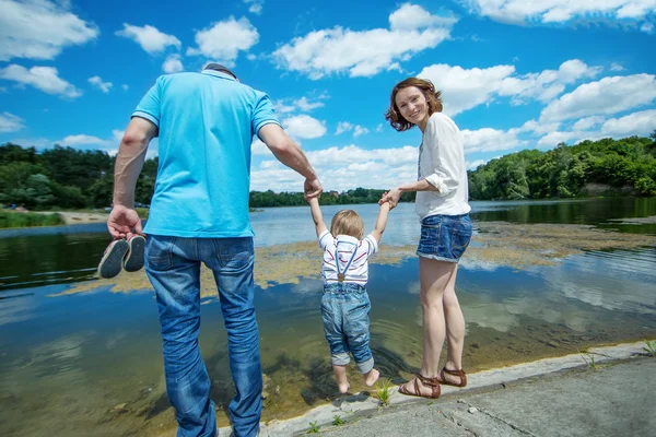 Jóvenes padres atractivos y retrato infantil al aire libre — Foto de Stock