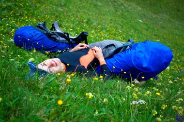 Uzun yürüyüşe çıkan kimse yeşil çayır üzerinde