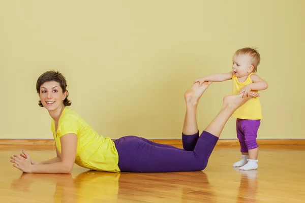 Mother do phisical exercises with her daughter at home — Stock Photo, Image