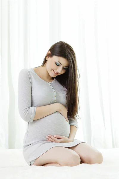 Pregnant  lovely female posing at studio — Stock Photo, Image