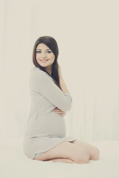 Pregnant  lovely female posing at studio — Stock Photo, Image