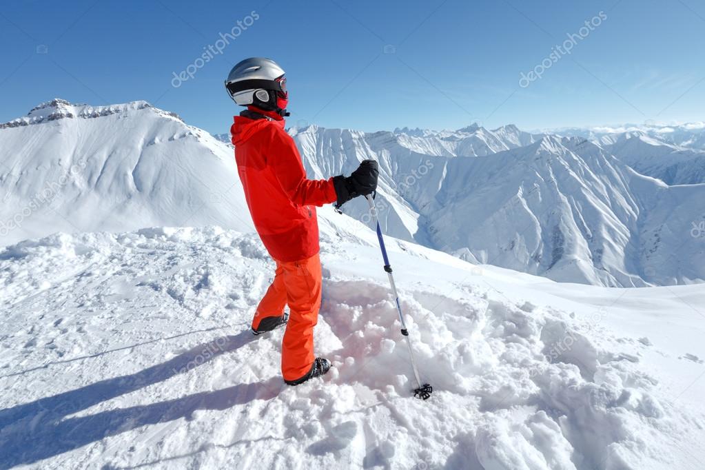 Skier takes a look at the slope before descent in the mountains