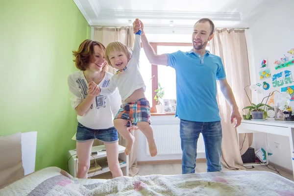 Jóvenes padres atractivos y retrato infantil en interiores — Foto de Stock