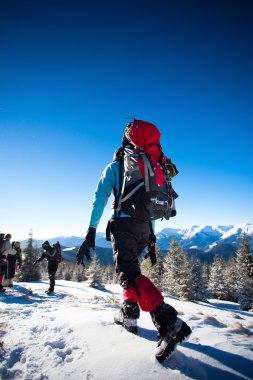 Kış dağlarında yürüyüş yapan