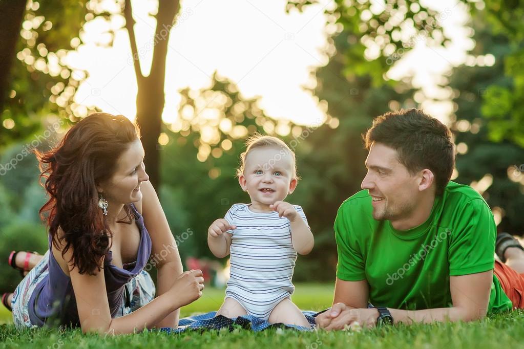 Young Attractive Parents and Child Portrait Outdoors