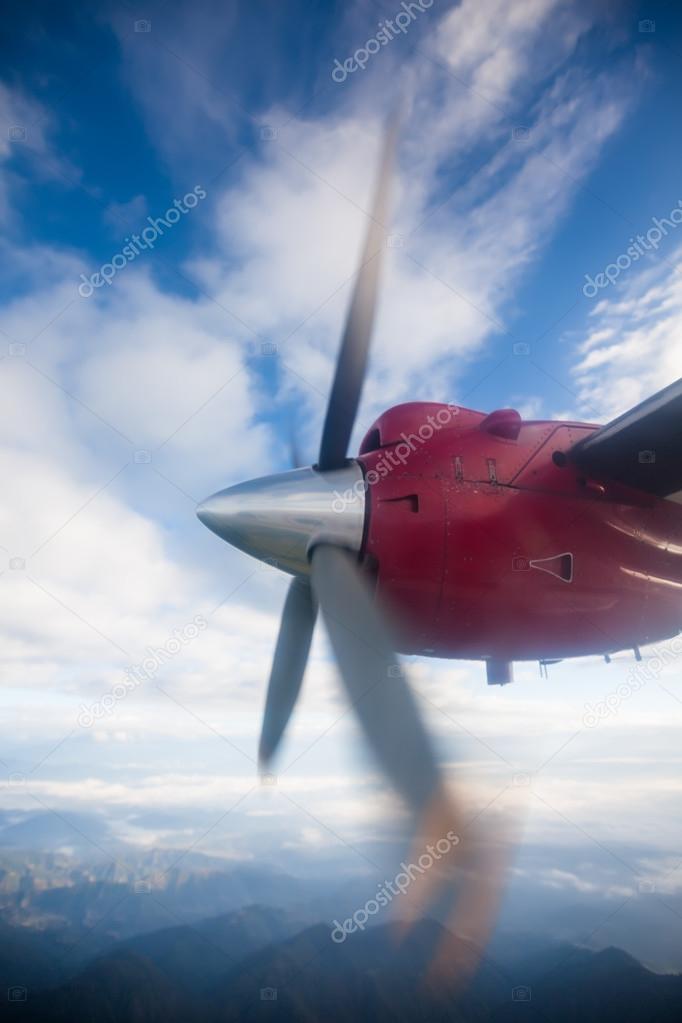 Propeller plane in air above Himalayas