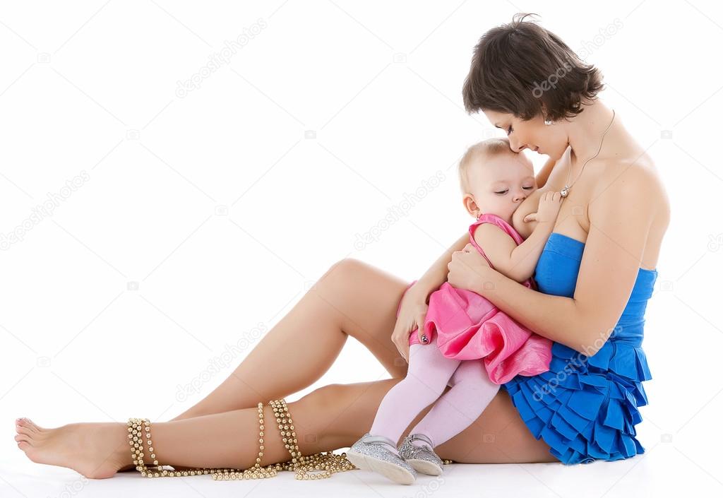 baby girl breast feeding at studio