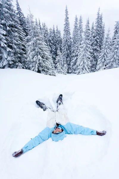 Hiker lying in snow in fores — Stock Photo, Image