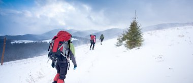 Kış dağlarında yürüyüş yapan