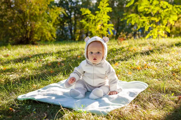 Cute caucasian baby boy in park looks at camera — Stock Photo, Image