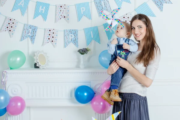 Portrait of mother and baby with birthday cake