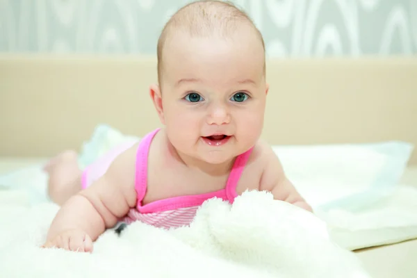 Sweet baby girl smiles at camera — Stock Photo, Image