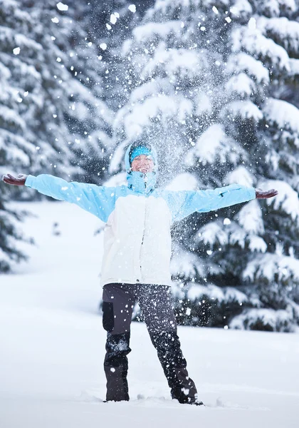 Hiker playing with snow in winter forest — Stock Photo, Image