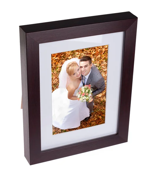 Photo frame with picture of happy couple on their weding day