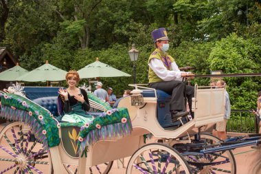 Orlando, Florida. July 29, 2020. Princess Anna riding a horse drawn carriage at Epcot (138)