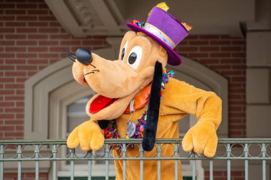Orlando, Florida. August 04, 2020. Pluto waving from the balcony at Walt Disney World Railroad at Magic Kingdom (387) clipart
