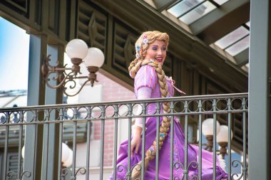 Orlando, Florida. August 04, 2020. Rapunzel waving from the balcony at Walt Disney World Railroad at Magic Kingdom (2) clipart
