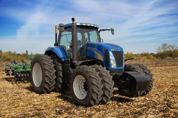 Modern farm tractor with planter — Stock Photo, Image