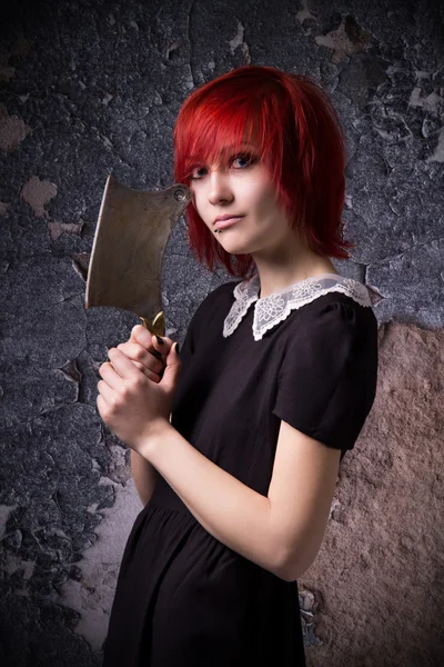 Red-haired girl with an ax Stock Picture