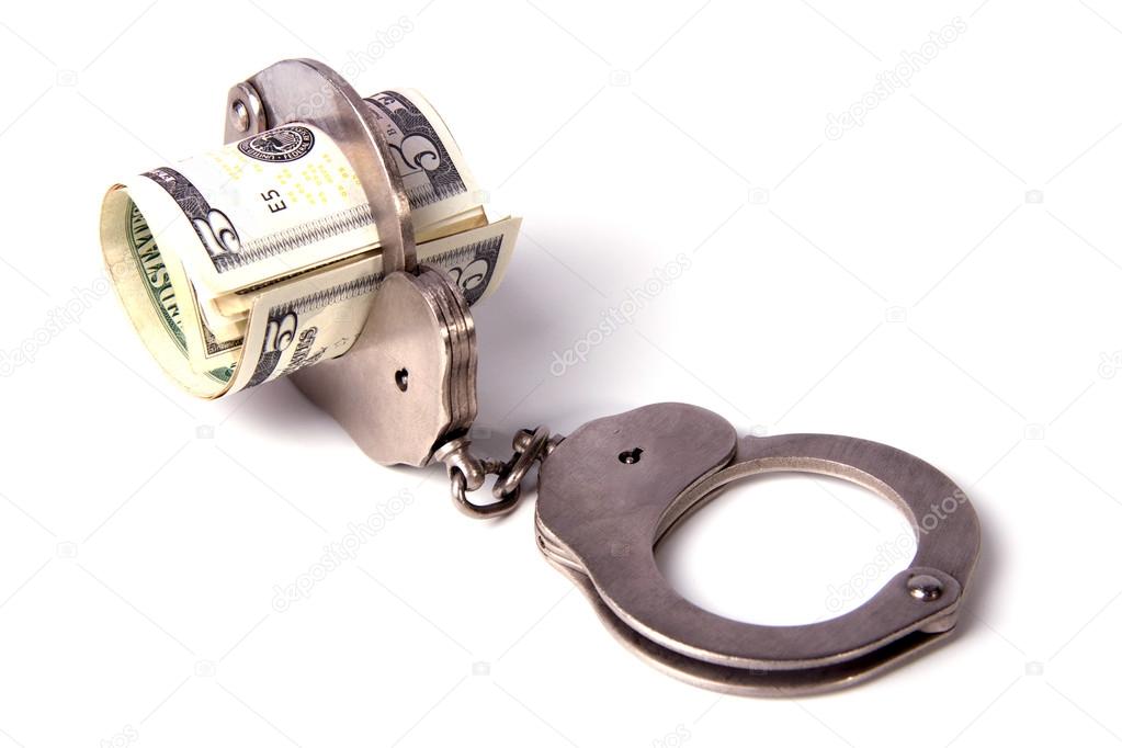 Steel handcuffs and a roll of dollars