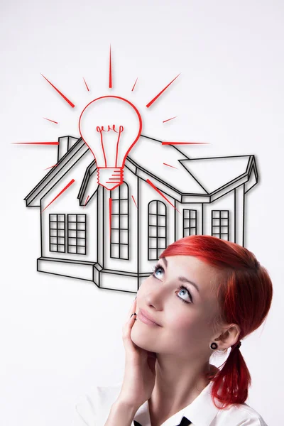 Red-haired girl dreams of your own home — Stock Photo, Image