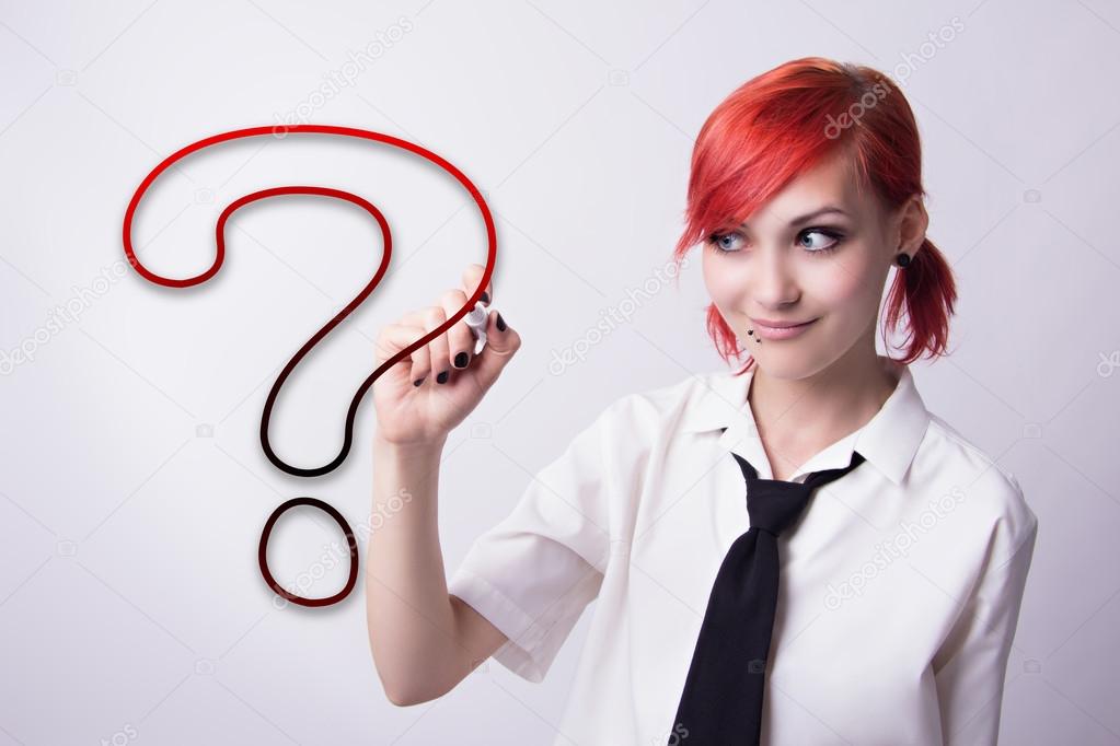 Beautiful girl draws a question mark marker