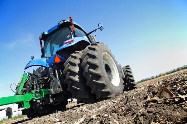 Farmer on a tractor plowed field — Stock Photo, Image