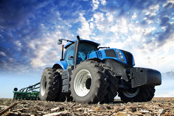 Modrý traktor pracující na farmě — Stock fotografie