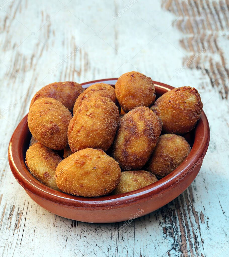 Croquettes surrounded by rustic background